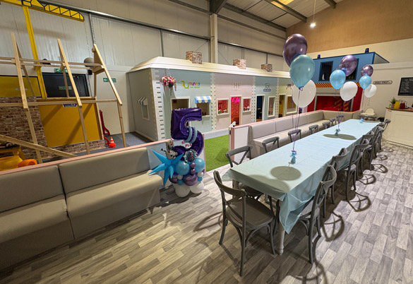 Children's birthday party table with balloons and decorations at Giggle Street Shrewsbury