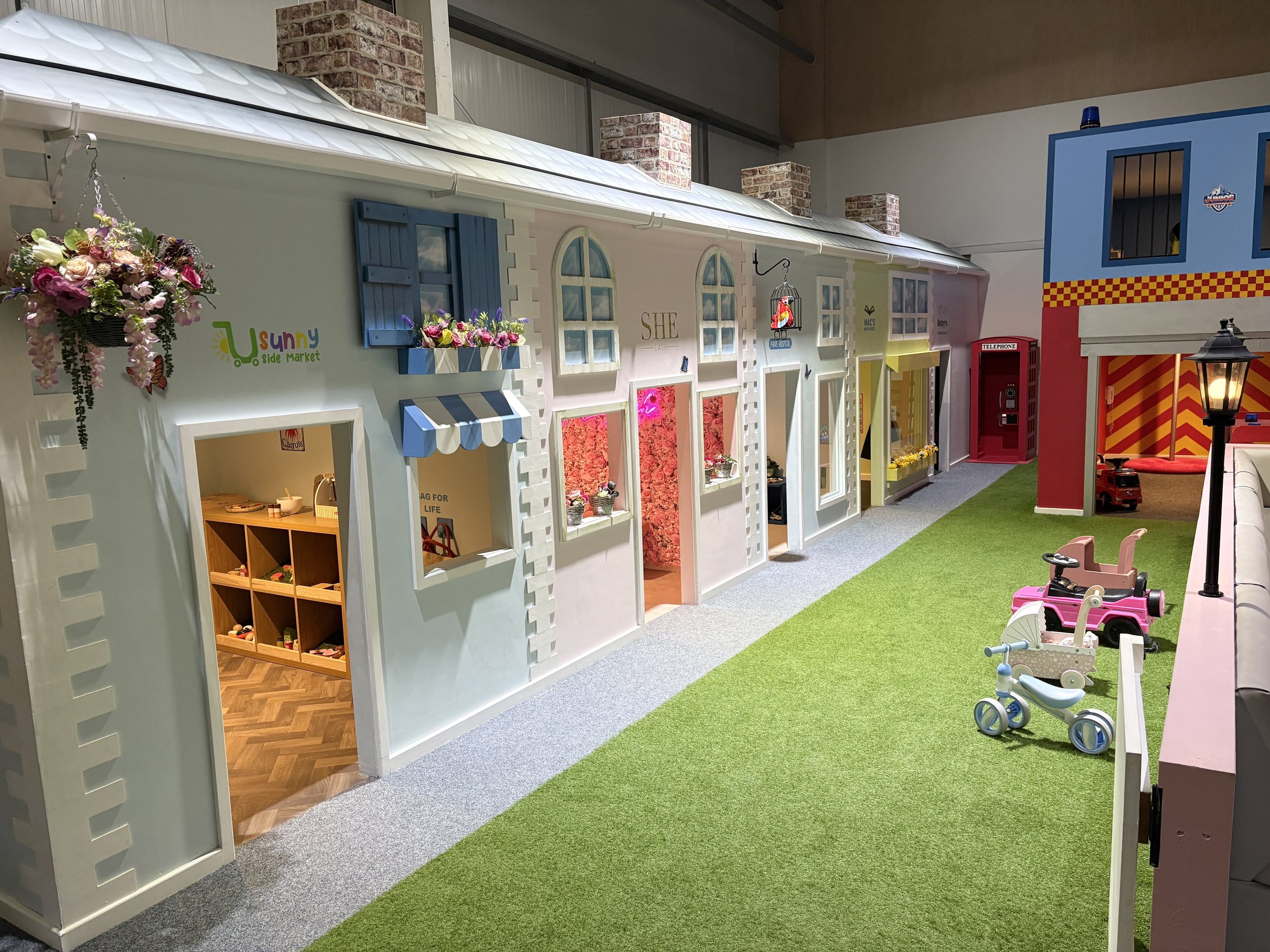 Inside Giggle Street Shrewsbury showing themed role play shop fronts for children